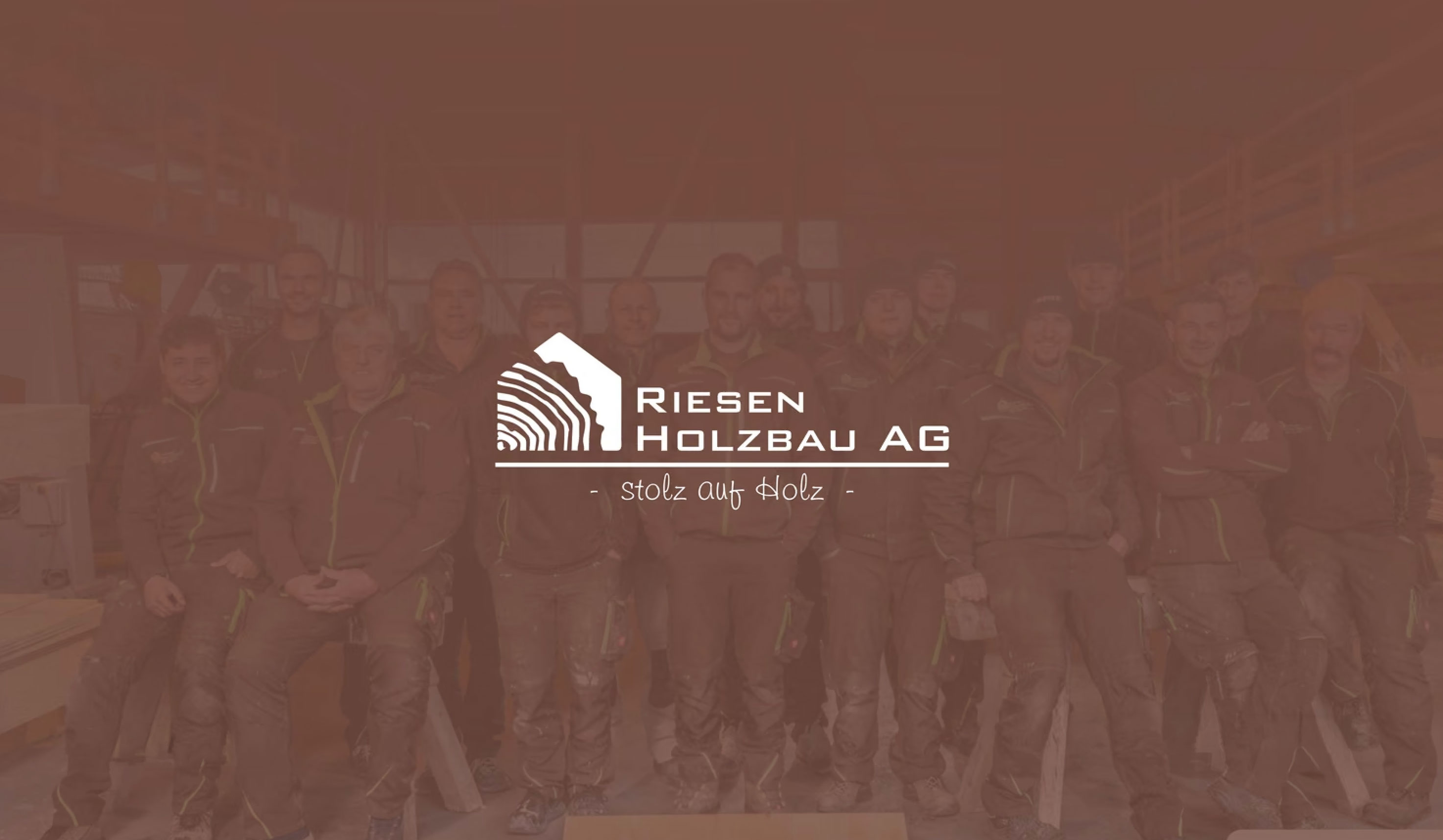 Riesen Holzbau AG logo in white, the house cut from a log beside the wordmark and Stolz auf Holz, over the team in brown
